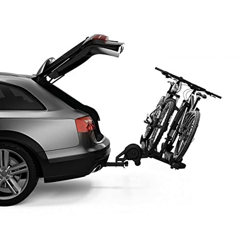 Car with a bike rack attached holding two bicycles.