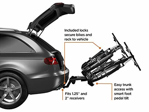 Car with bike rack attached to the trunk, showing two bicycles mounted.