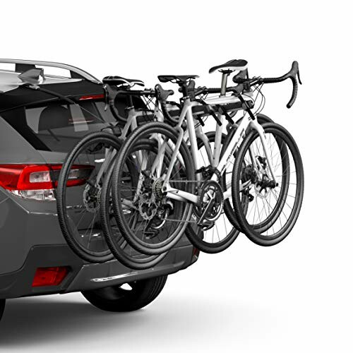 Car with two bicycles mounted on a rear bike rack.