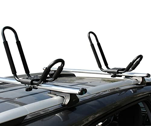 Car roof rack with kayak holders installed.