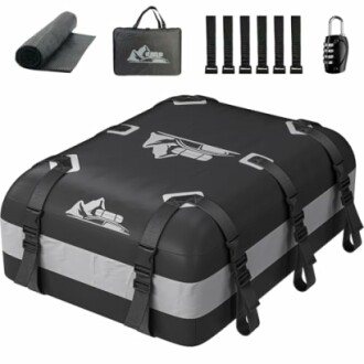 Car rooftop cargo carrier with accessories including mat, straps, and lock.