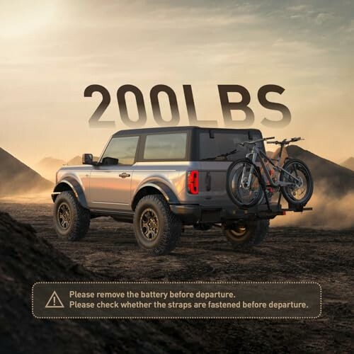 SUV with bikes on rear rack in desert landscape.