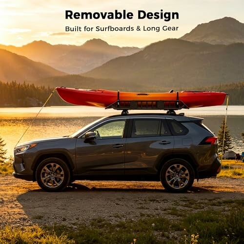 SUV with kayak on roof parked by lake at sunset.